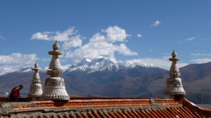 Temple and monk over the mountains in Ganzi