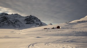 Sunset on the mountains with the sleeping dog teams, Greenland